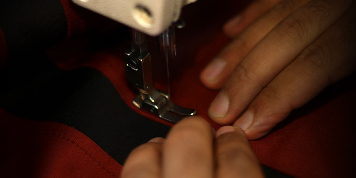 sewing machine operator and red cloth